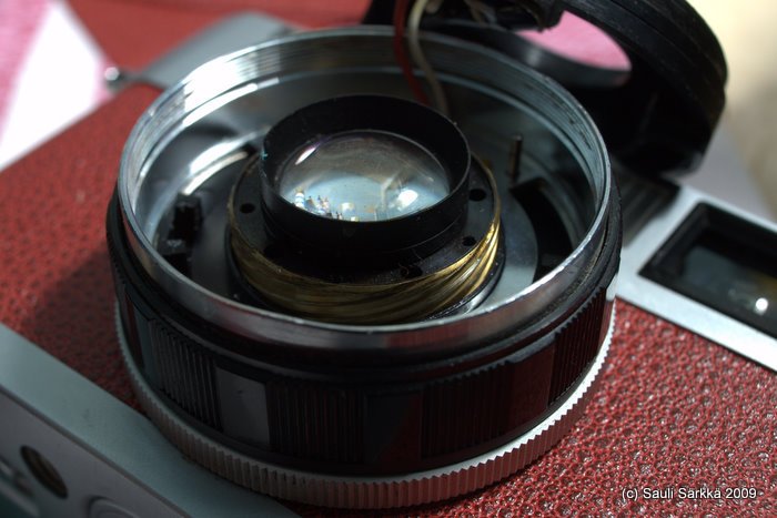 oly_35_rc_front_lens_4.jpg - With the ring off, the front assembly can simply be rotated counter-clockwise, raising it out of the helicoid. Be sure that the area around the element is very clean, as the shutter is now revealed when the element is raised out of the assembly. You don't want anything extra on one of the most sensitive parts of the rangefinder.